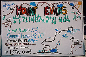 sign at entry to Mt Evans road - Temp here: 52 F, Summit Temperature 28 F high, 0 F low - Trail map