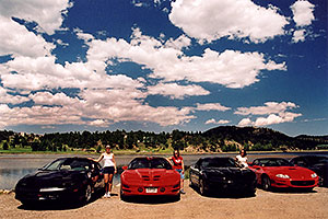 Ewka, Aneta and Ola with black and red Pontiac TransAm cars at Estes Lake