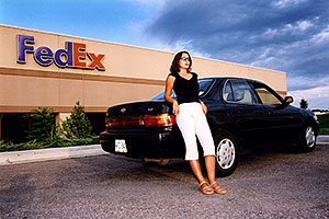 Ola with her black Toyota Camry by Fedex in Englewood