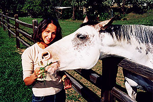 Ola feeding a white horse