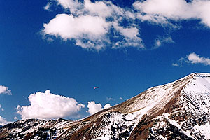 Red Paraglider west of Cinnamon Mountain