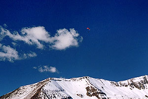 Red Paraglider west of Cinnamon Mountain
