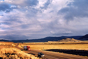 red semi truck heading to Gunnison in the late October afternoon … Yaks to the right 