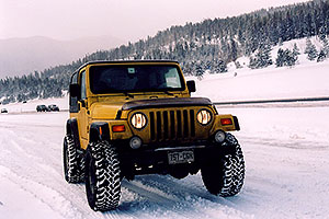 yellow Jeep Wrangler at overview of Dillon Lake