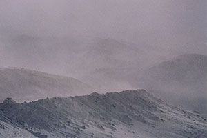 car approaching top of Loveland Pass in snowstorm