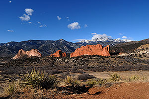 view of Garden of the Gods with Pikes Peak in the clouds