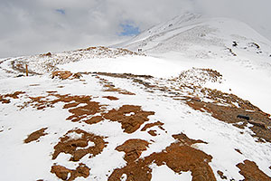 hikers walking up east face of Loveland Pass