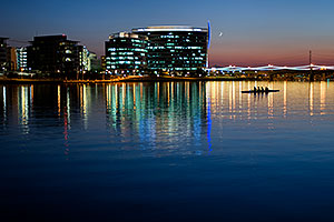 4 person sculling boat (plust captain at the front) at Tempe Town Lake under a crescent moon