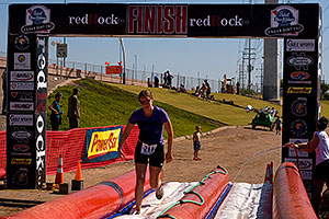 02:54:42 Runner finishing on a water slide - PBR Offroad Triathlon, Oct 11, 2009 at Tempe Town Lake