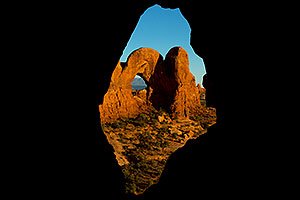 View of Double Arch through Cove Arch in Cove of Caves in Arches National Park