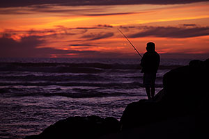 Fishing at sunset by Carlsbad, California