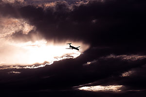 Plane and angry sky clouds